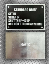 Load image into Gallery viewer, “Standard Brief: Get In, Strap In, Shut The F**k Up” Military Humour Car plaque