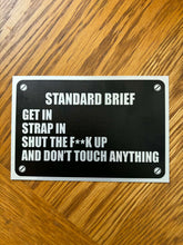 Load image into Gallery viewer, “Standard Brief: Get In, Strap In, Shut The F**k Up” Military Humour Car plaque